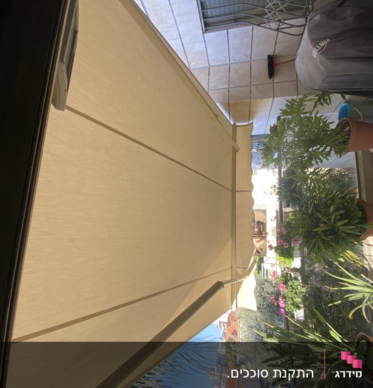 awning on a balcony with plants underneath